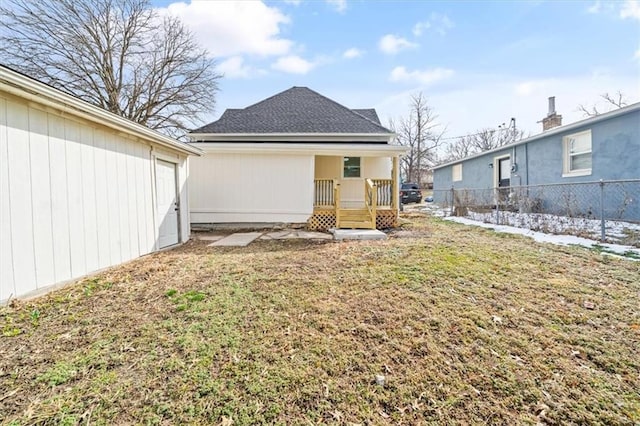 back of house featuring a yard and fence