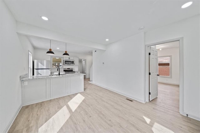 living room with baseboards, visible vents, and light wood finished floors