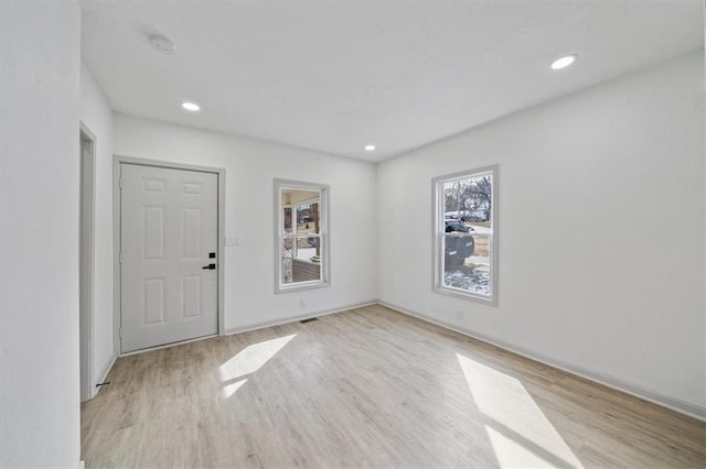 foyer entrance with recessed lighting, baseboards, and wood finished floors