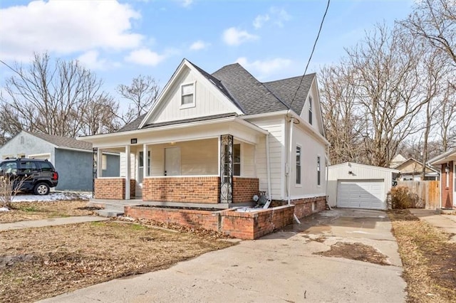 view of front of home featuring an outbuilding, driveway, a porch, a garage, and brick siding