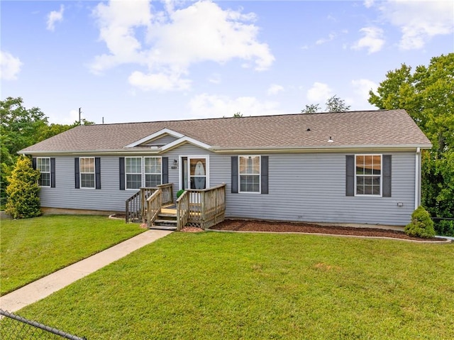 1310 Lawrence Ave, Kansas City, KS 66103 - ranch-style home with a front lawn and a shingled roof