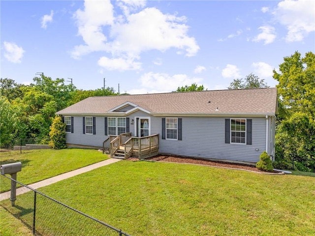 1310 Lawrence Ave, Kansas City, KS 66103 - ranch-style house featuring a front lawn and fence
