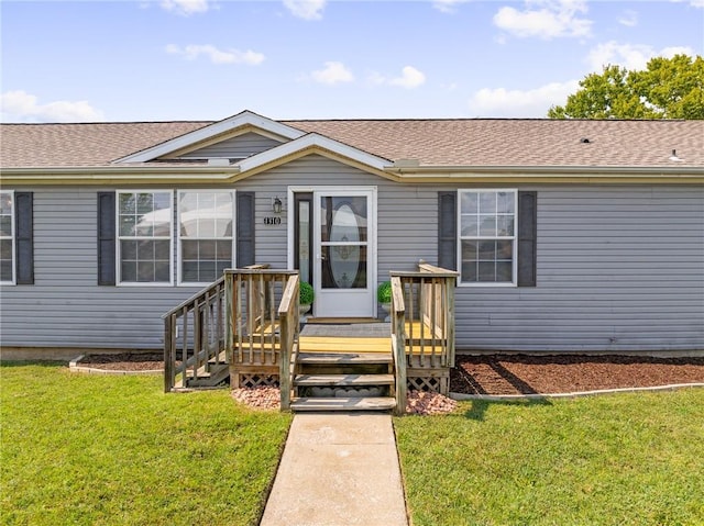 1310 Lawrence Ave, Kansas City, KS 66103 - view of front facade with roof with shingles and a front lawn