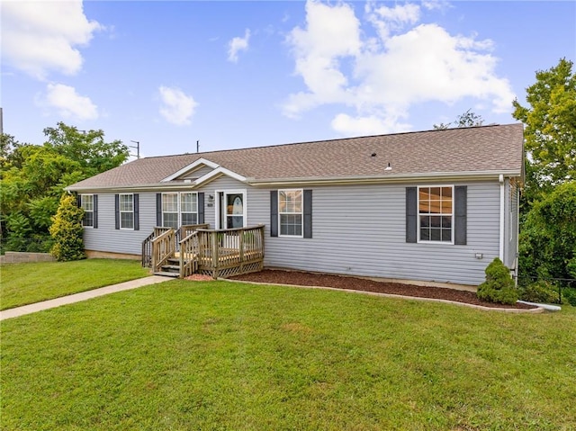 1310 Lawrence Ave, Kansas City, KS 66103 - single story home featuring a wooden deck, a front yard, and a shingled roof