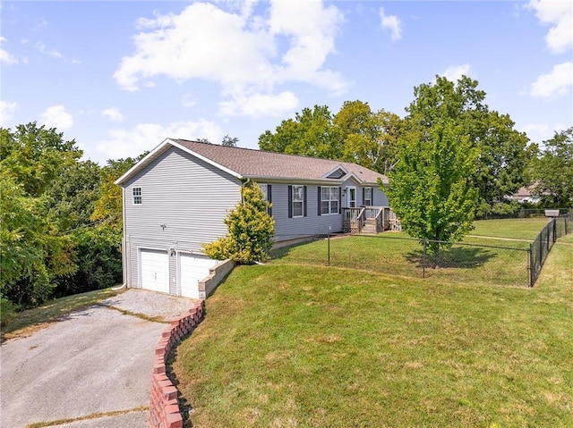 1310 Lawrence Ave, Kansas City, KS 66103 - view of front facade with a garage, a front yard, driveway, and fence