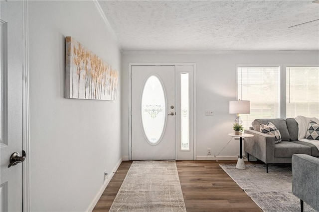 1310 Lawrence Ave, Kansas City, KS 66103 - entrance foyer with ornamental molding, wood finished floors, baseboards, and a textured ceiling