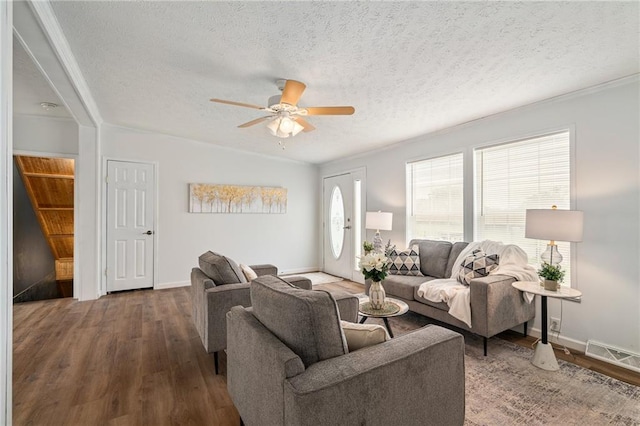 1310 Lawrence Ave, Kansas City, KS 66103 - living area featuring visible vents, a textured ceiling, a ceiling fan, and wood finished floors