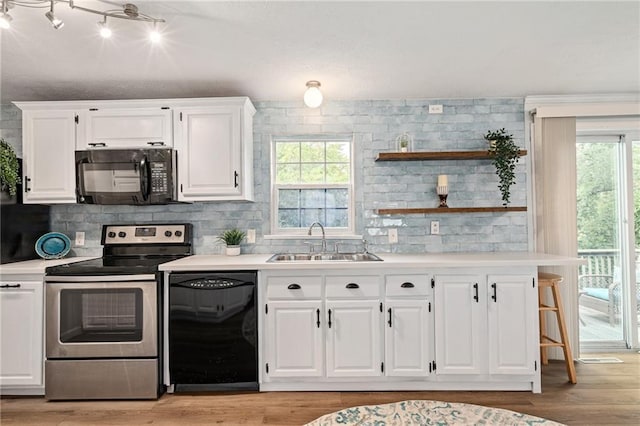 1310 Lawrence Ave, Kansas City, KS 66103 - kitchen featuring white cabinetry, black appliances, open shelves, and a sink