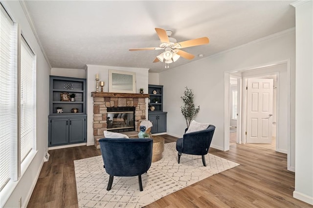 1310 Lawrence Ave, Kansas City, KS 66103 - living area featuring plenty of natural light, a stone fireplace, wood finished floors, and ornamental molding