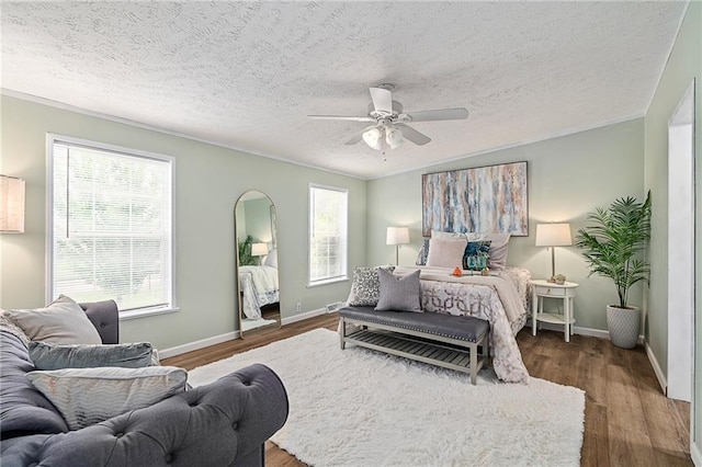 1310 Lawrence Ave, Kansas City, KS 66103 - bedroom featuring baseboards, ornamental molding, wood finished floors, a textured ceiling, and a ceiling fan