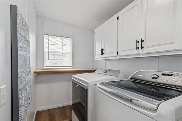 1310 Lawrence Ave, Kansas City, KS 66103 - laundry area with cabinet space, wood finished floors, and washing machine and clothes dryer