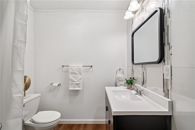 1310 Lawrence Ave, Kansas City, KS 66103 - bathroom with toilet, wood finished floors, crown molding, baseboards, and vanity