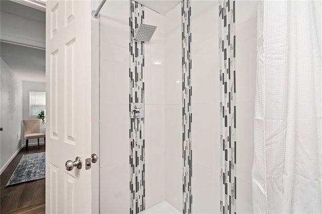 1310 Lawrence Ave, Kansas City, KS 66103 - full bathroom featuring baseboards, wood finished floors, and a tile shower