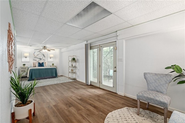 1310 Lawrence Ave, Kansas City, KS 66103 - sitting room with a ceiling fan, wood finished floors, baseboards, and a paneled ceiling