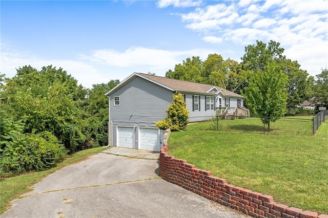 1310 Lawrence Ave, Kansas City, KS 66103 - view of front of home featuring a front yard, an attached garage, fence, and driveway