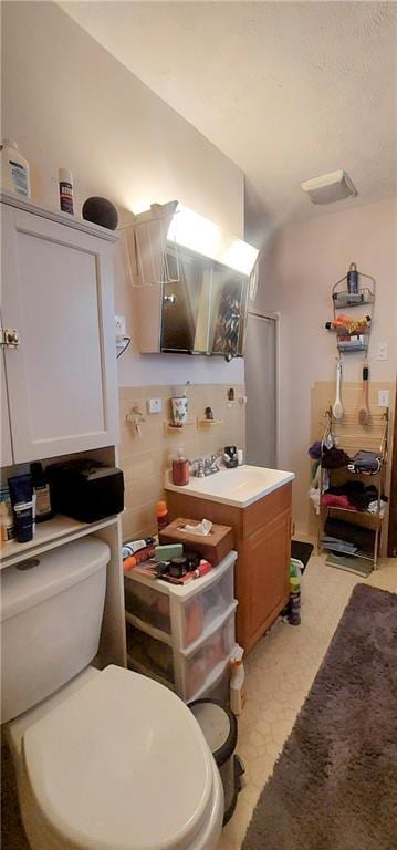 kitchen with light floors, a sink, and white cabinetry