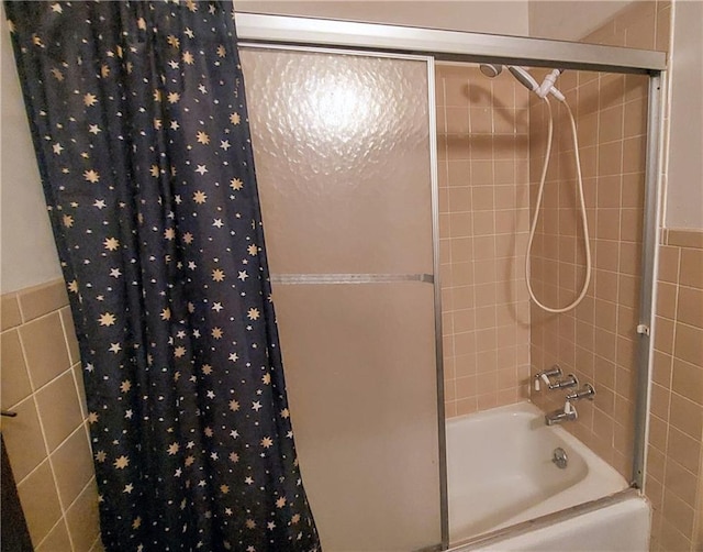 bathroom with tile walls and shower / bathtub combination with curtain