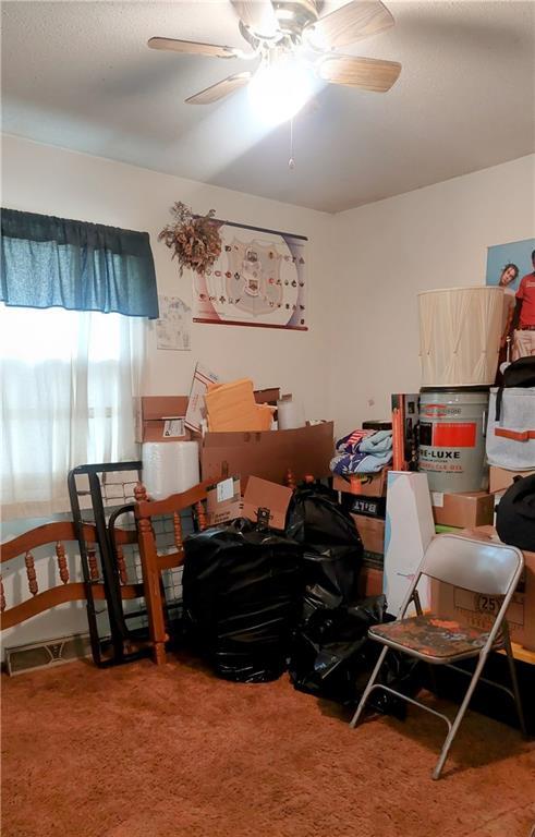 storage room featuring visible vents and a ceiling fan