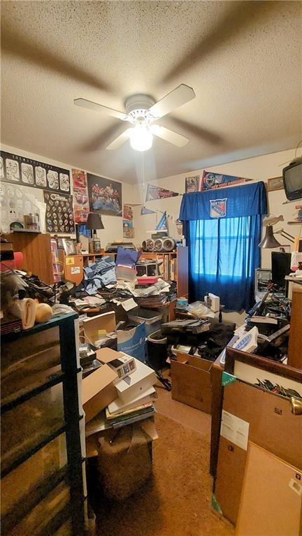 office with ceiling fan and a textured ceiling