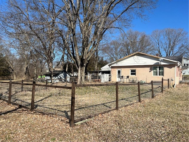 view of home's exterior featuring brick siding and fence private yard