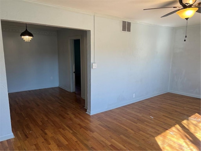 spare room with visible vents, baseboards, ceiling fan, and wood finished floors