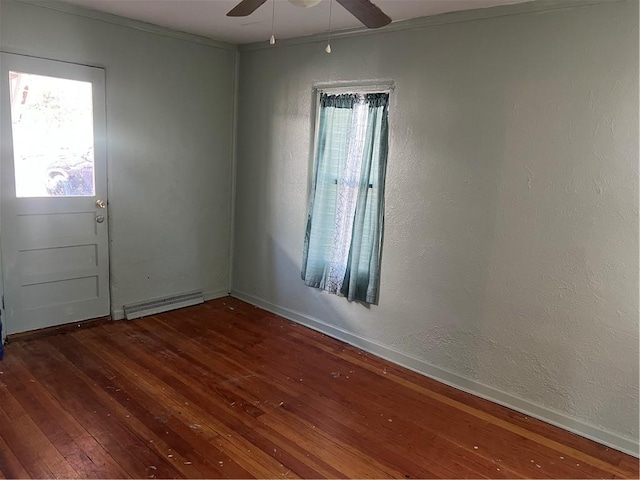 empty room featuring a textured wall, visible vents, a ceiling fan, and hardwood / wood-style flooring