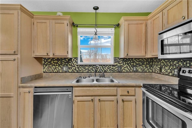 kitchen with a sink, light countertops, light brown cabinets, and stainless steel appliances