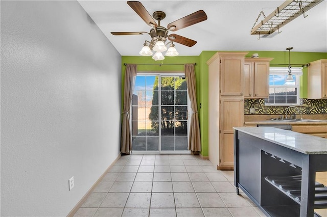 kitchen featuring plenty of natural light, backsplash, light brown cabinets, and a sink