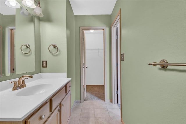 bathroom featuring tile patterned floors, baseboards, and vanity