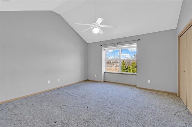 unfurnished bedroom with a ceiling fan, lofted ceiling, carpet, and baseboards