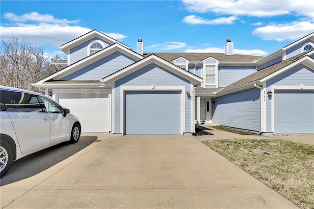 view of front of house featuring concrete driveway and an attached garage