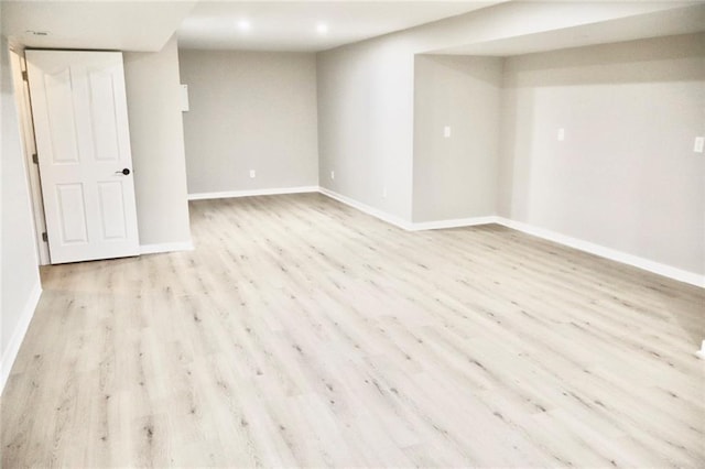 unfurnished room featuring baseboards and wood finished floors