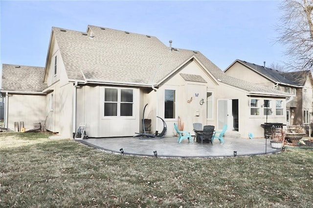 rear view of property with a yard, a patio, and a shingled roof