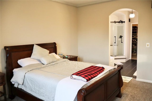 carpeted bedroom with arched walkways, baseboards, and ornamental molding