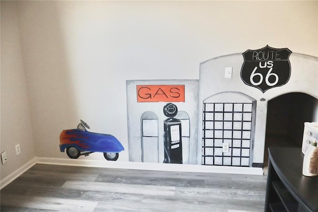 interior details featuring baseboards and wood finished floors