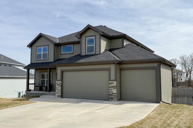 craftsman house featuring a garage, concrete driveway, a shingled roof, and fence