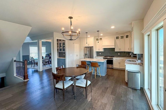 kitchen with stainless steel appliances, a center island, decorative backsplash, dark wood finished floors, and custom range hood