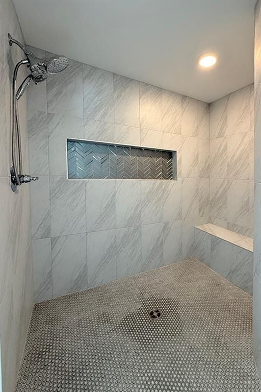 full bath featuring a tile shower