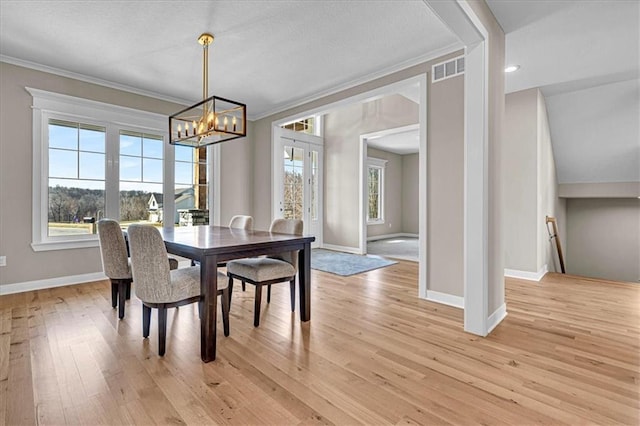 dining area with baseboards, a healthy amount of sunlight, light wood-type flooring, and ornamental molding