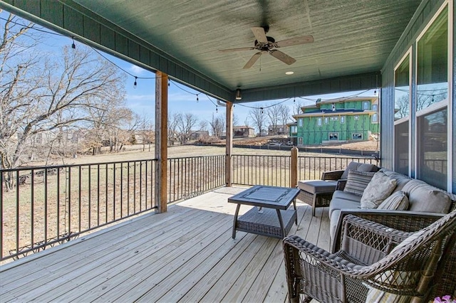 deck featuring an outdoor living space and ceiling fan