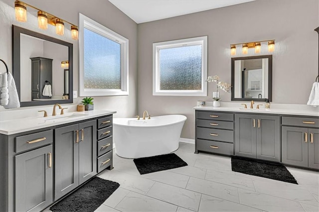 bathroom featuring marble finish floor, two vanities, and a sink