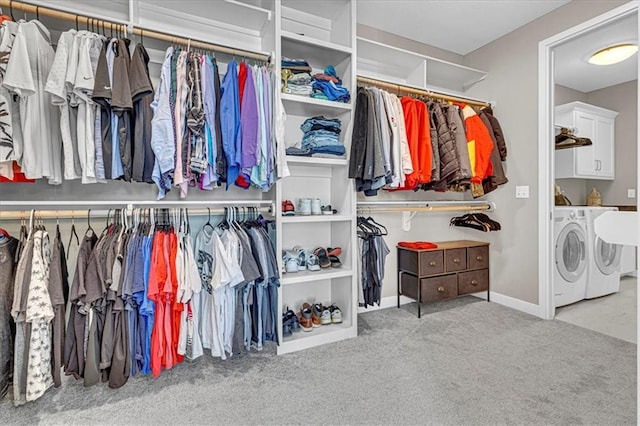 walk in closet featuring separate washer and dryer and carpet flooring