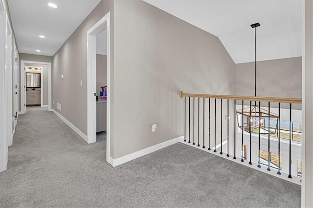 corridor featuring recessed lighting, baseboards, lofted ceiling, and carpet floors