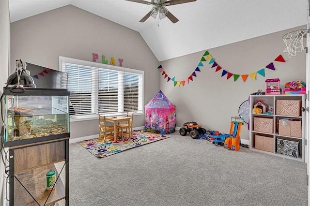 playroom with carpet floors, baseboards, ceiling fan, and vaulted ceiling