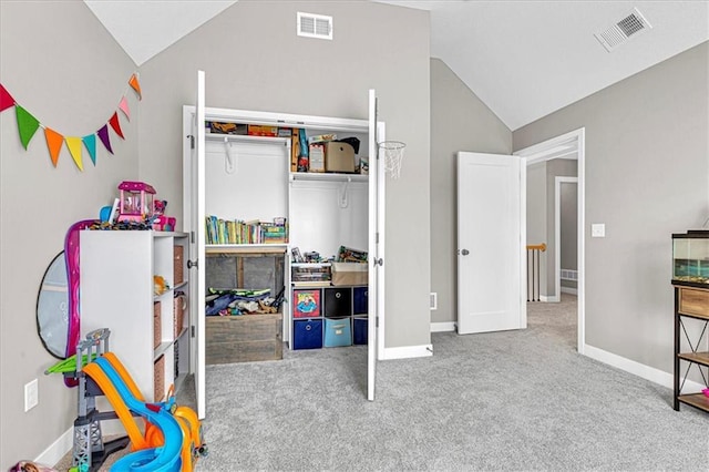 bedroom featuring vaulted ceiling, carpet flooring, and visible vents