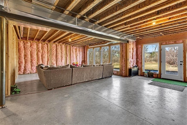 unfurnished living room featuring concrete flooring