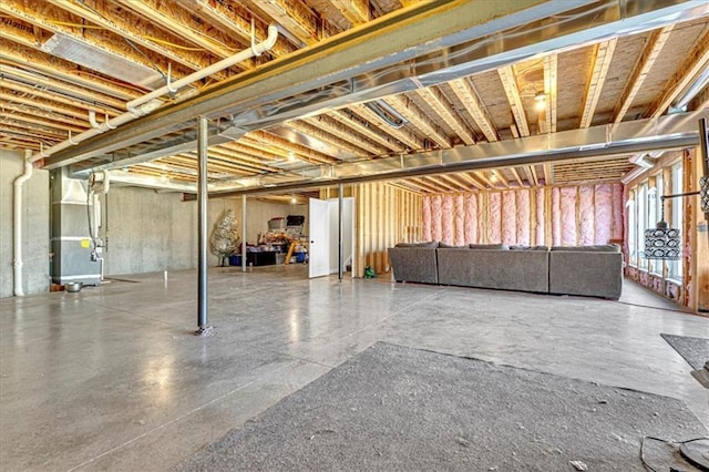 unfinished basement featuring heating unit