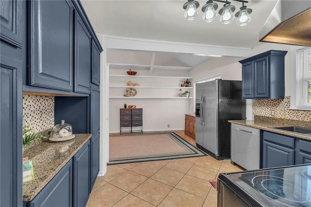 kitchen with blue cabinetry, decorative backsplash, appliances with stainless steel finishes, and light tile patterned flooring