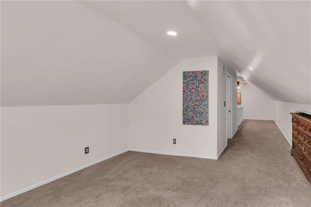 additional living space featuring recessed lighting, baseboards, light colored carpet, and vaulted ceiling