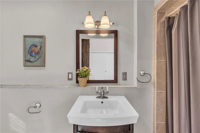 bathroom featuring curtained shower and vanity